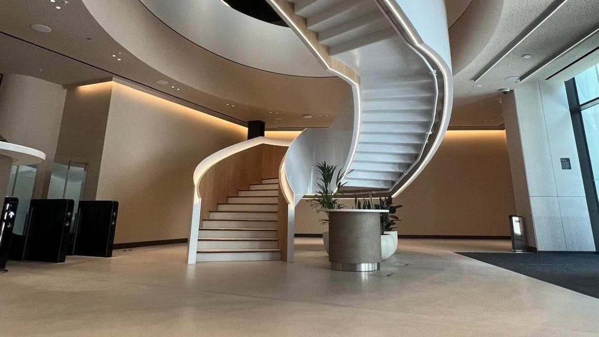 Curved staircase with integrated LED handrail lighting